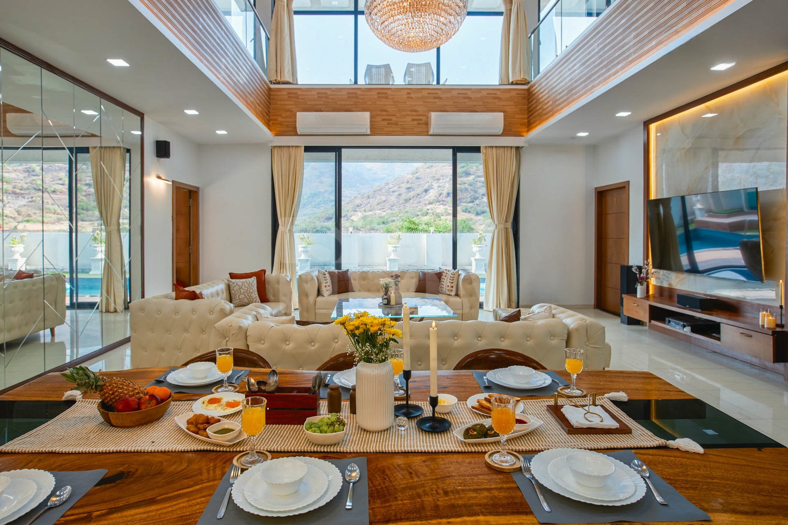 DOUBLE-HEIGHT LIVING – 16-foot crystal chandelier centred over the room, full-height windows.